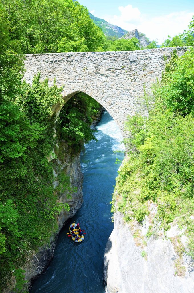 Discover the medieval Lauzet Ubaye bridge seen from a rafting trip