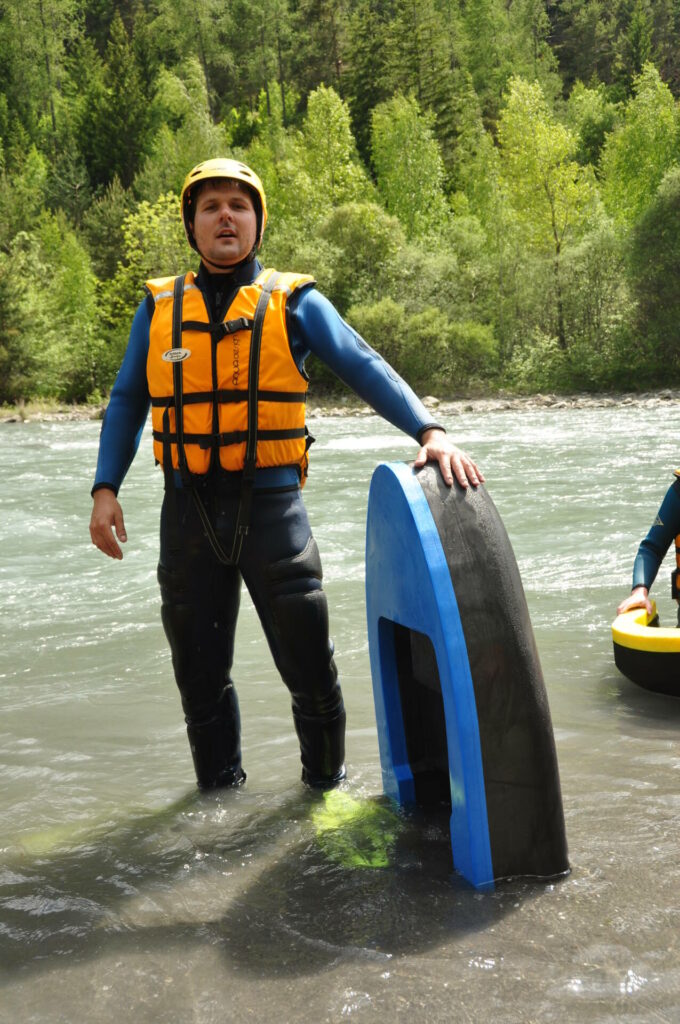 Un équipement d'hydrospeed sur l'Ubaye barcelonnette : combinaison, palmes flotteur gilet et casque jaune